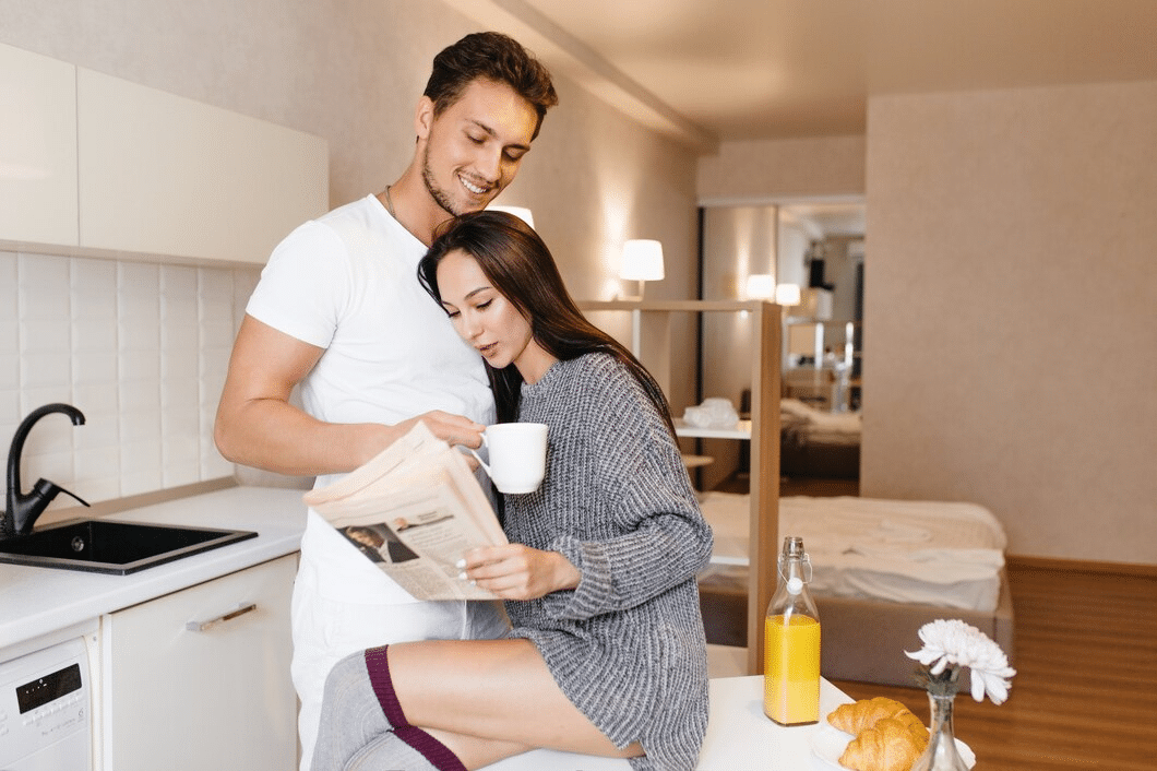 A young couple in the kitchen embracing