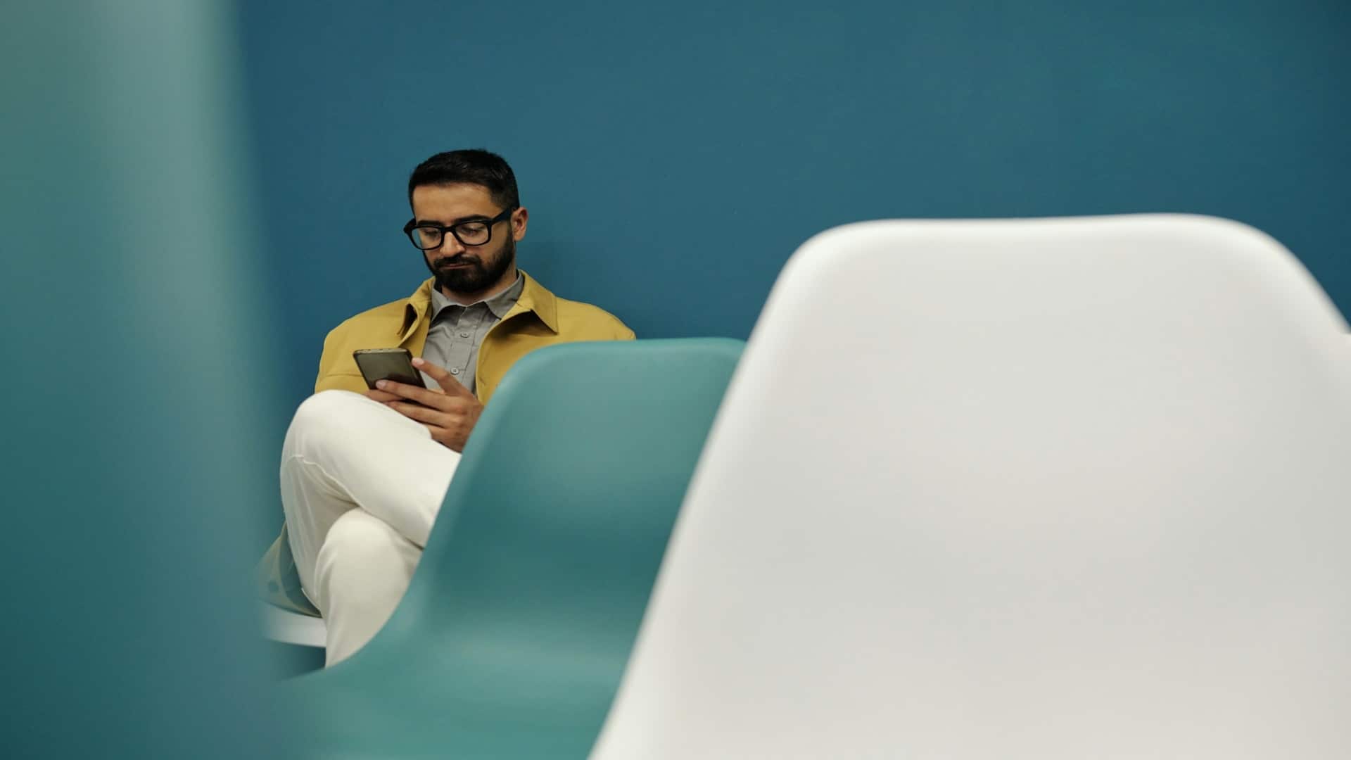 man sitting casually looking at phone