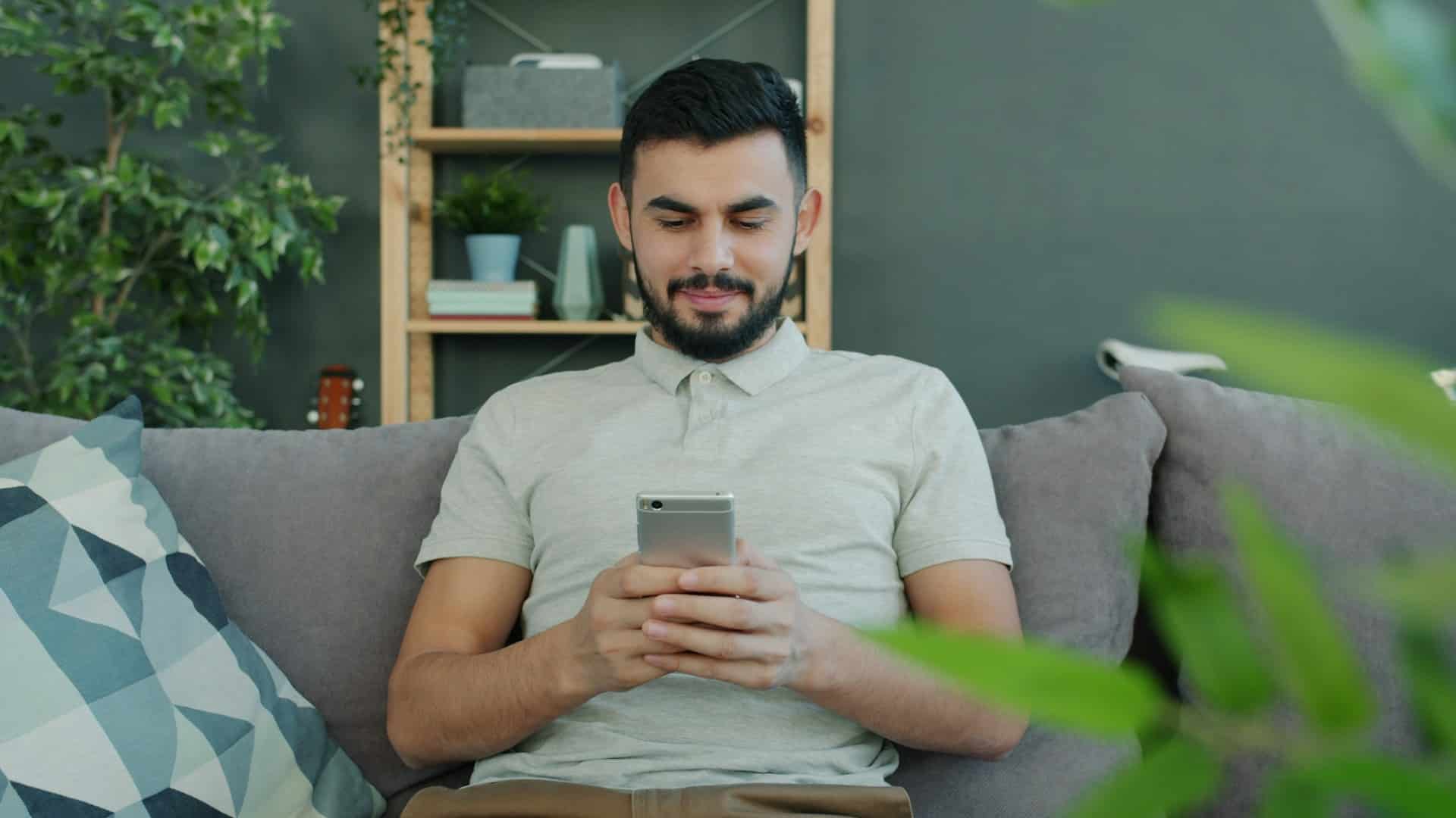 person smiling while texting