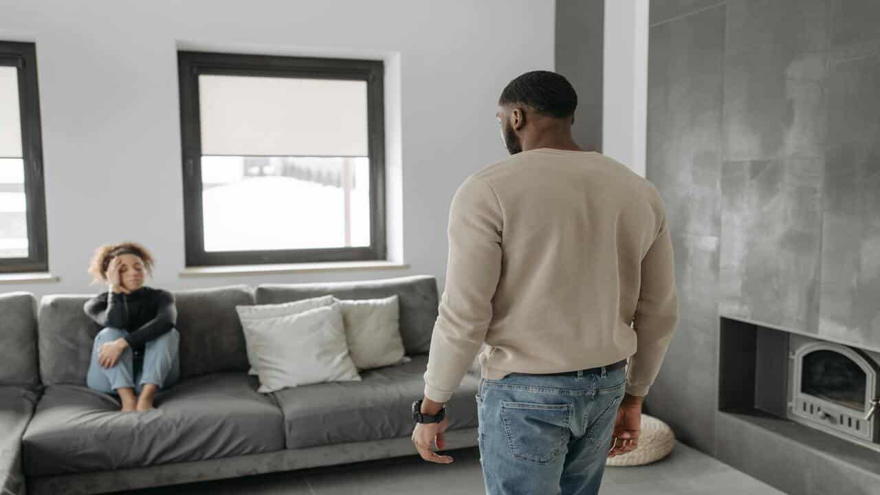 A couple looking somber at home