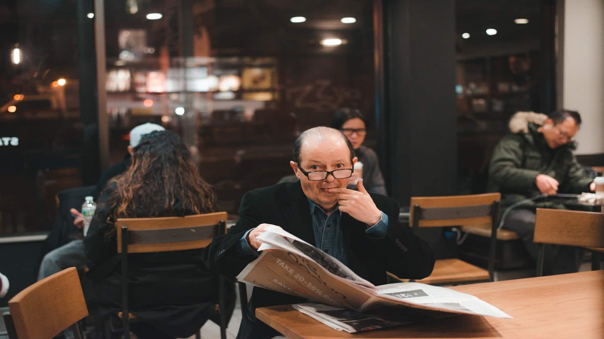 man observing conversation quietly