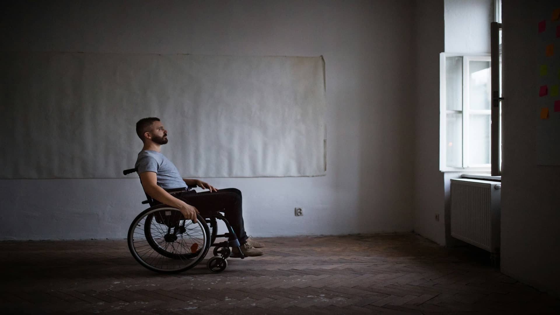 man sitting thoughtfully indoors