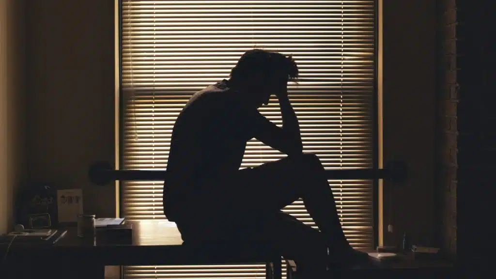 A man looking depressed at home