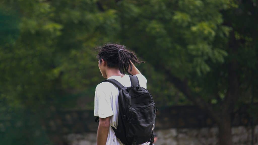 man thinking while walking outdoors