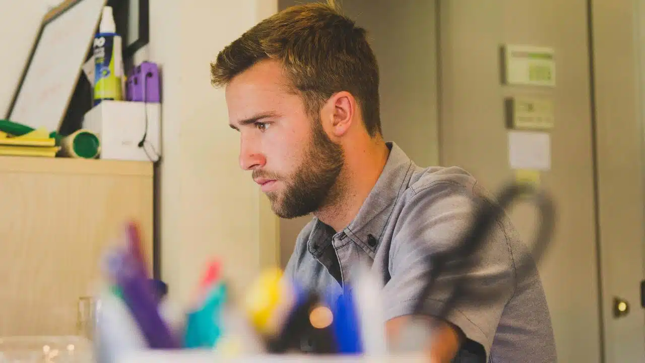 A focused man works at a desk