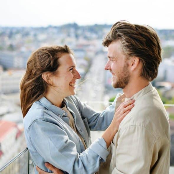 A smiling couple standing close together