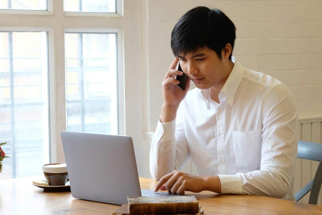 man using phone desk focus