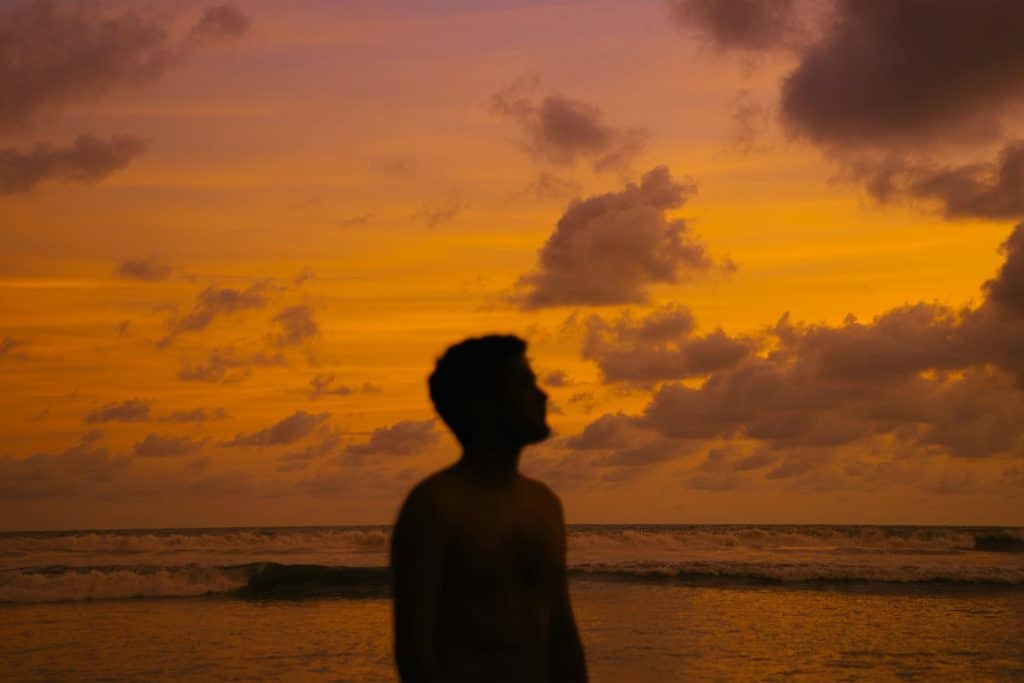 man reflective sunset