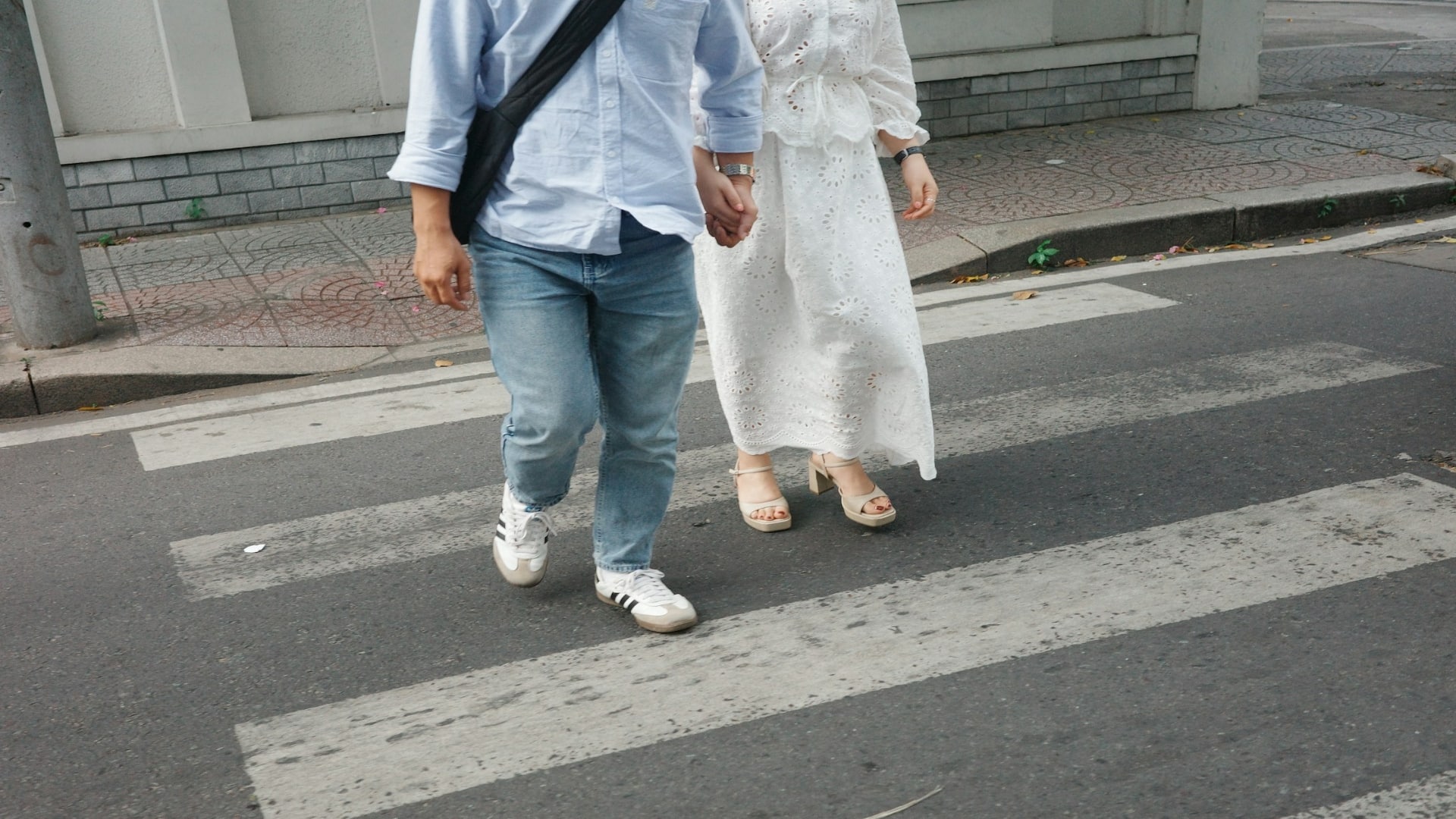 man helping partner cross street