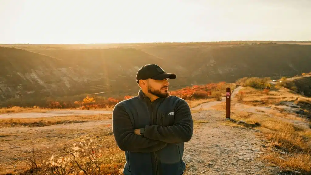 man standing thoughtfully outdoors