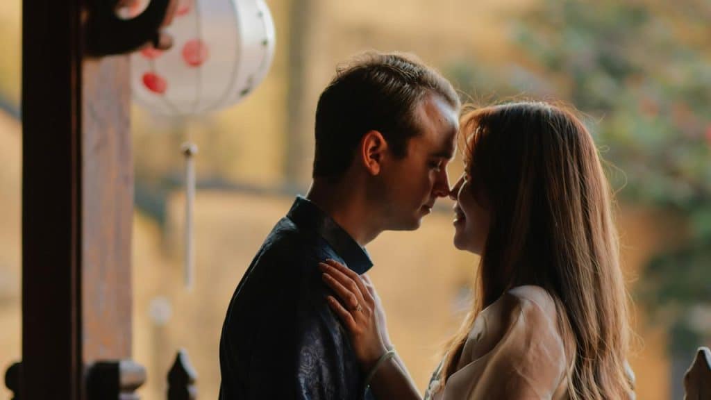 A couple standing close indoors