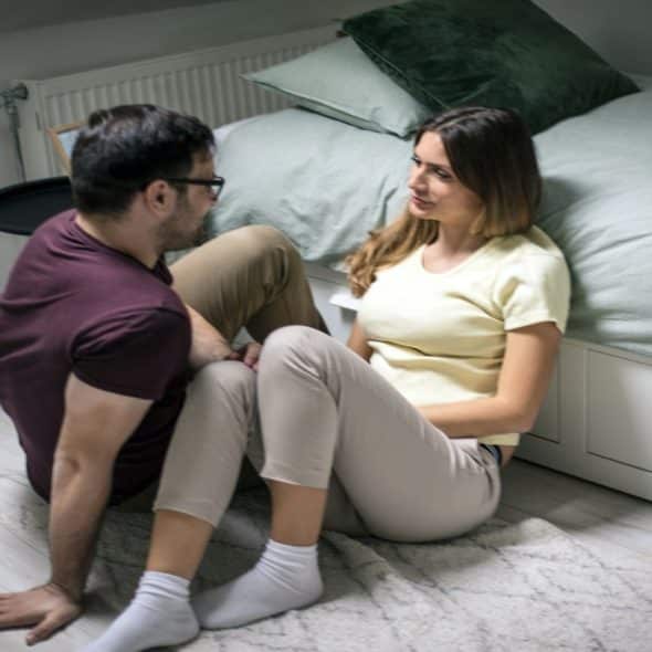 man sitting quietly while partner looks at him