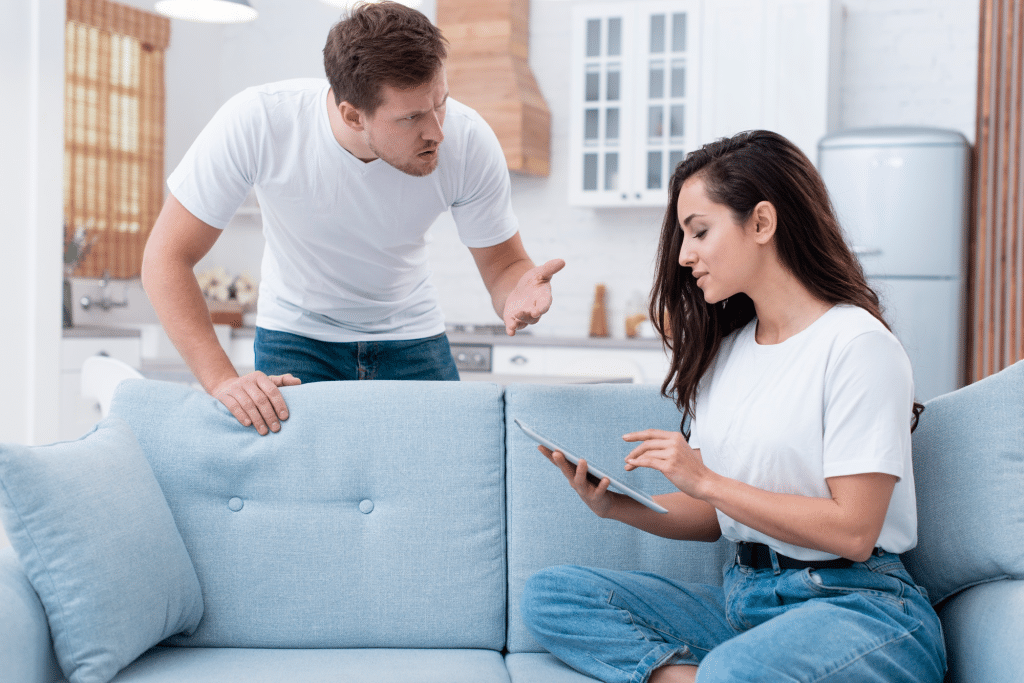 Couple on couch with different body languages