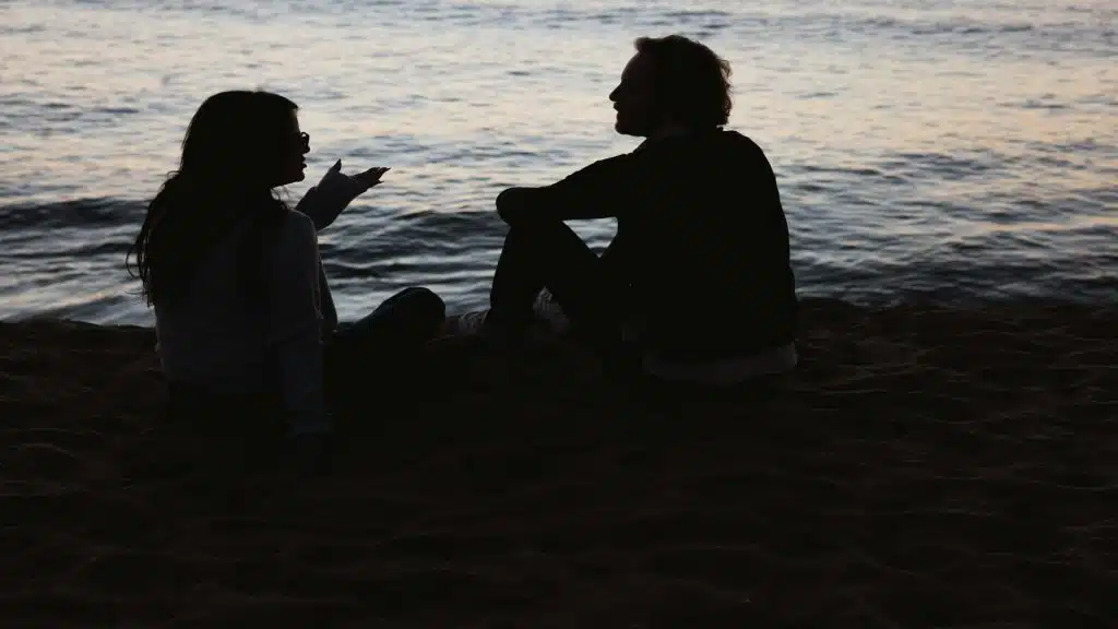 couple sitting together but looking distant