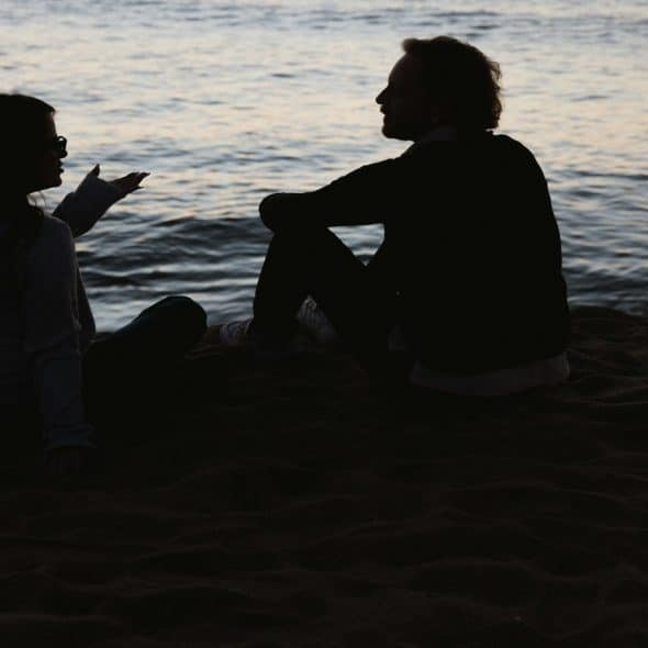 couple sitting together but looking distant