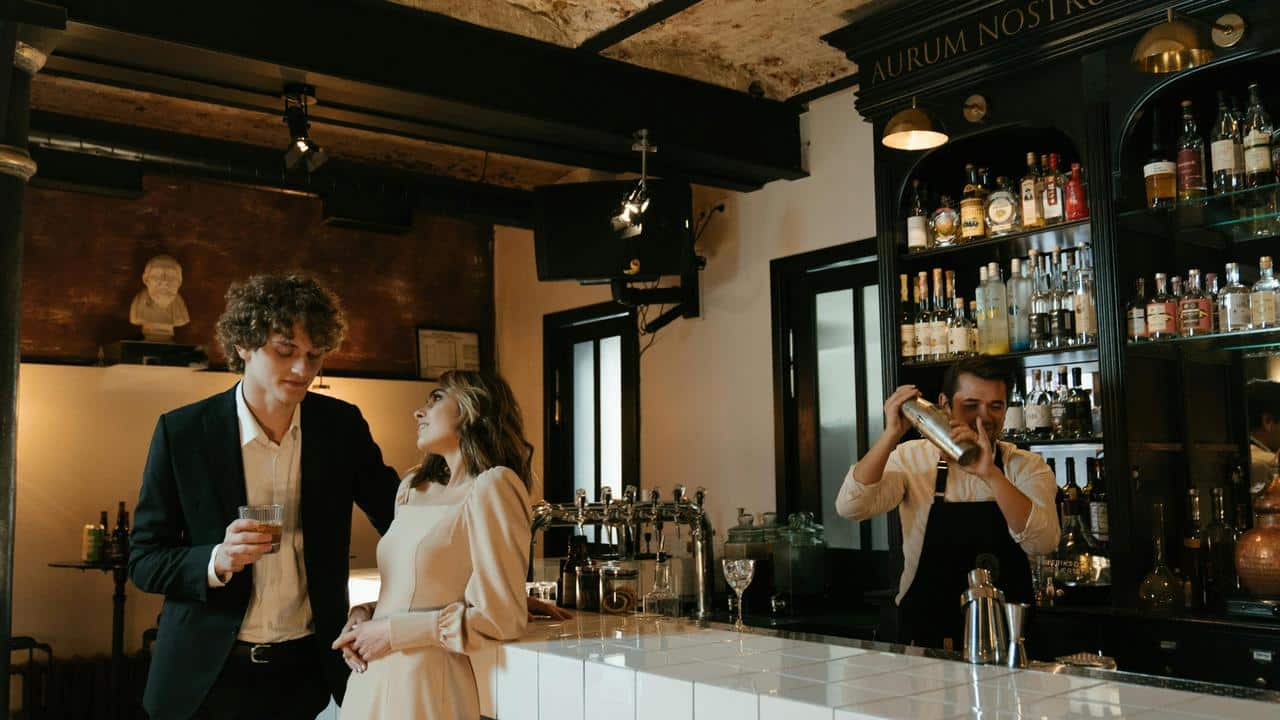 A couple standing at a bar