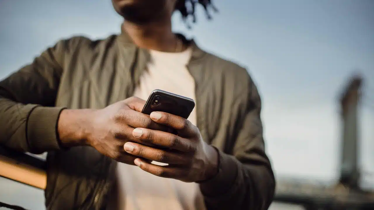 A man holding and using a smartphone