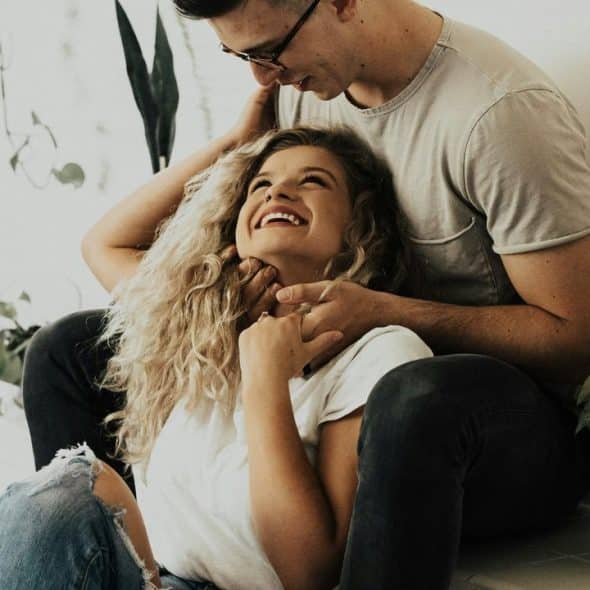 A happy couple sitting indoors