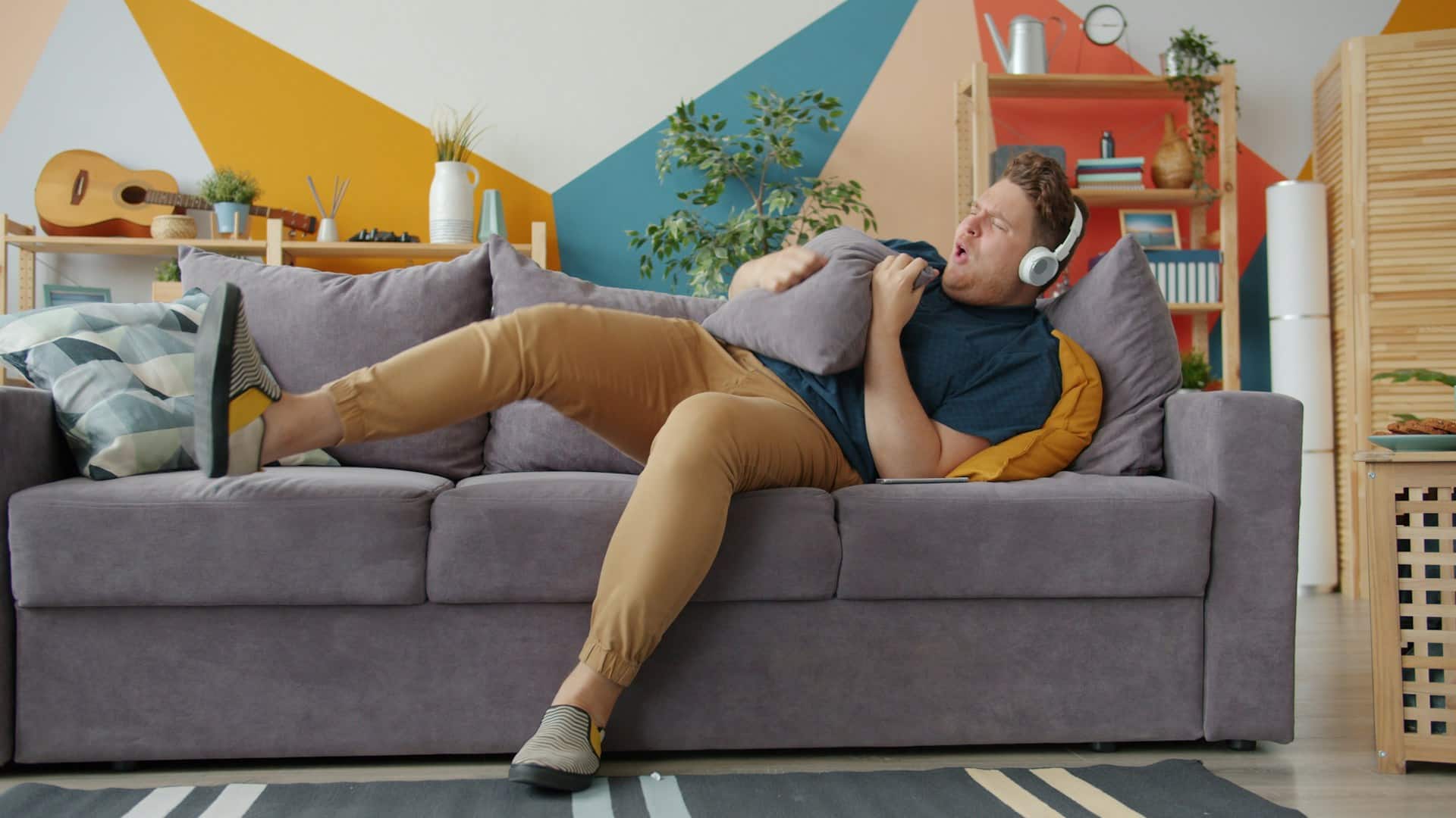 man sitting passively on couch