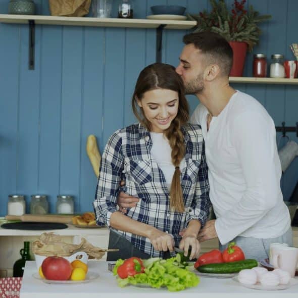A couple hugging in the kitchen