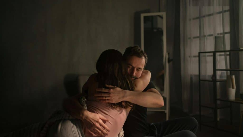 A man hugging a woman