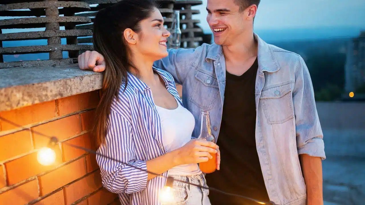 A smiling couple standing outdoors