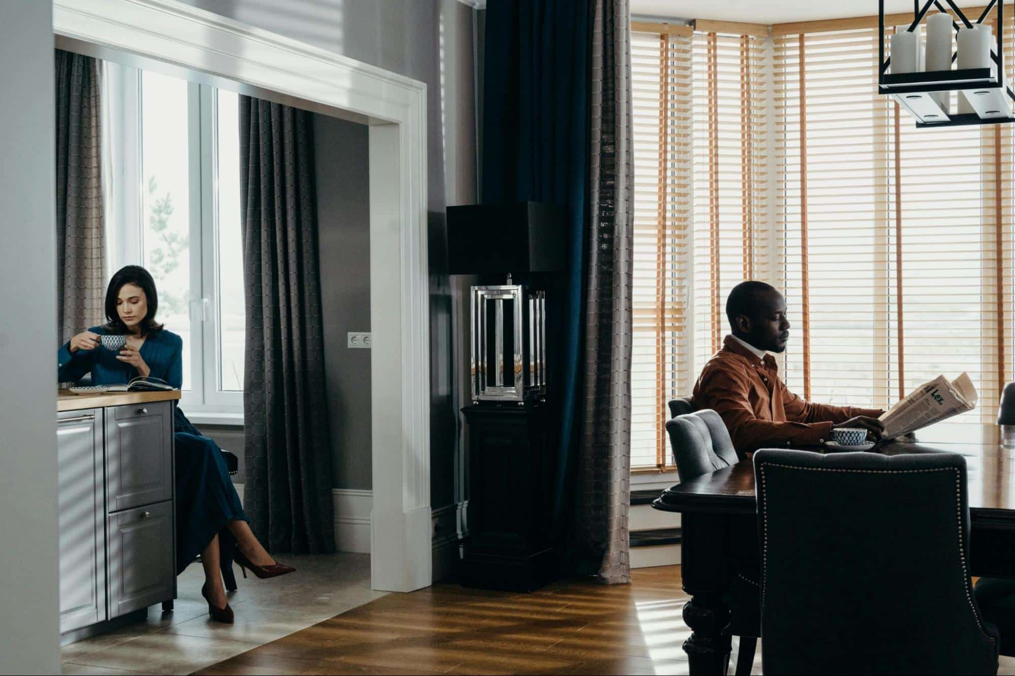 A man and a woman in the same room, but with different priorities