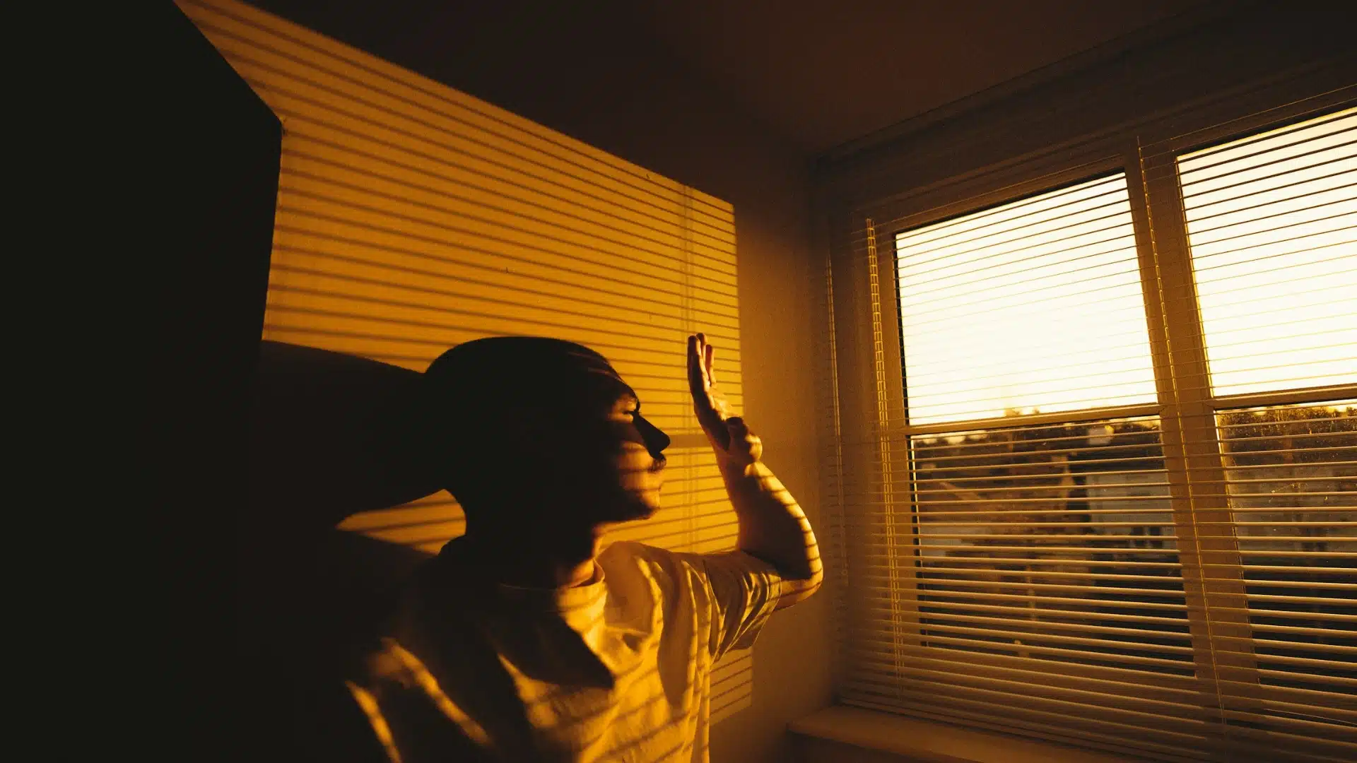 man looking reflective near window