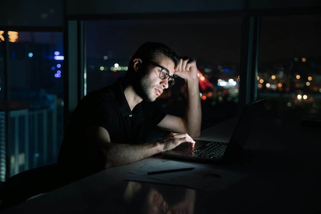 man working late office