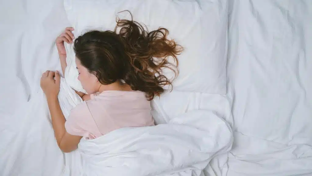 A woman sleeps on a bed