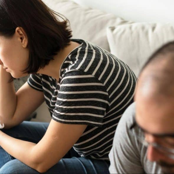 A woman stressed and a man ignoring her