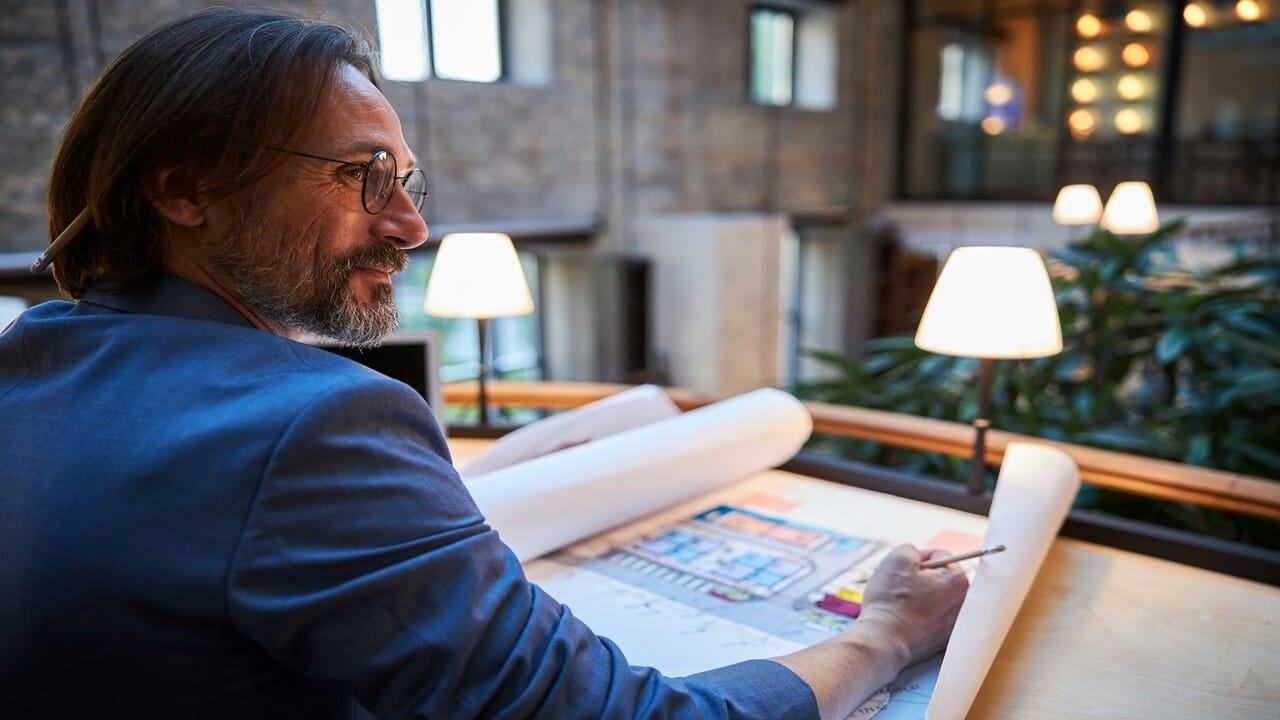 A man smiling while working