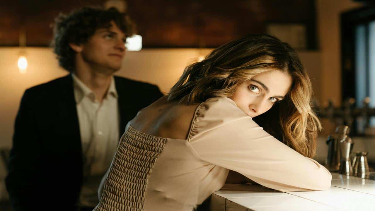 A man rolling his eyes while his date looks away