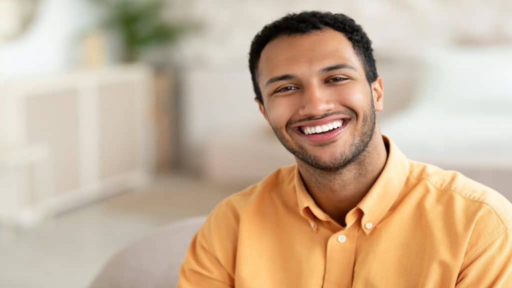 man smiling comfortably with partner