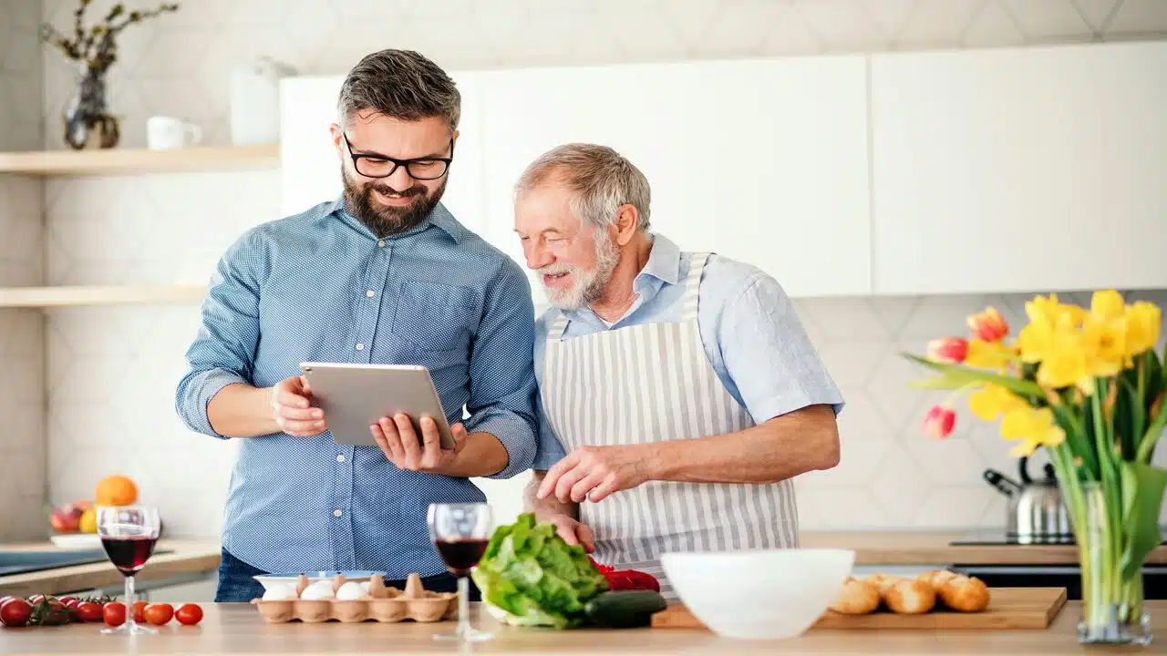 A father and a son looking at something on an iPad