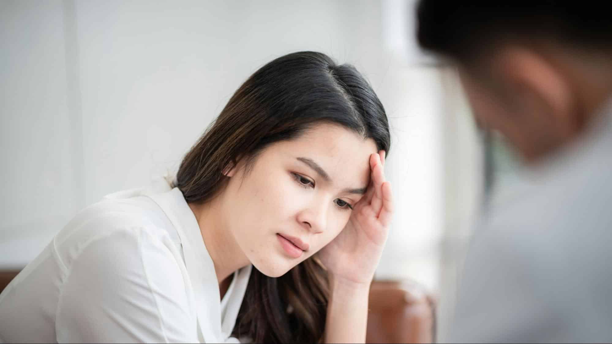 A woman holding her head