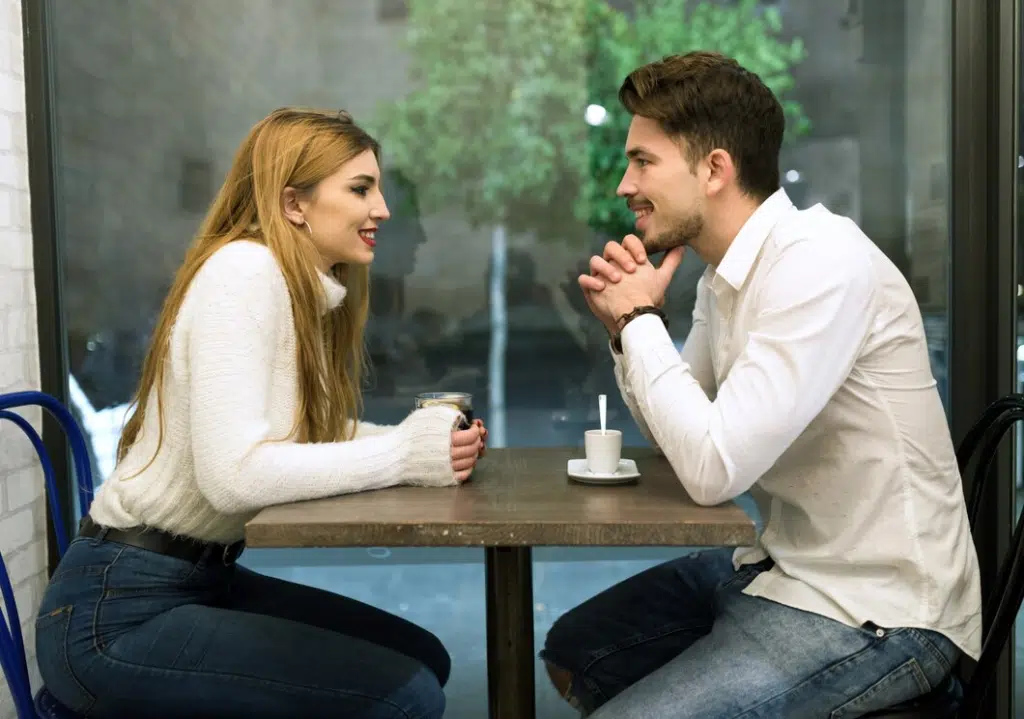 Young couple chatting and smiling outdoors