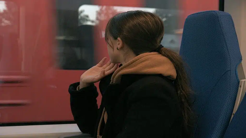 person sitting quietly avoiding eye contact