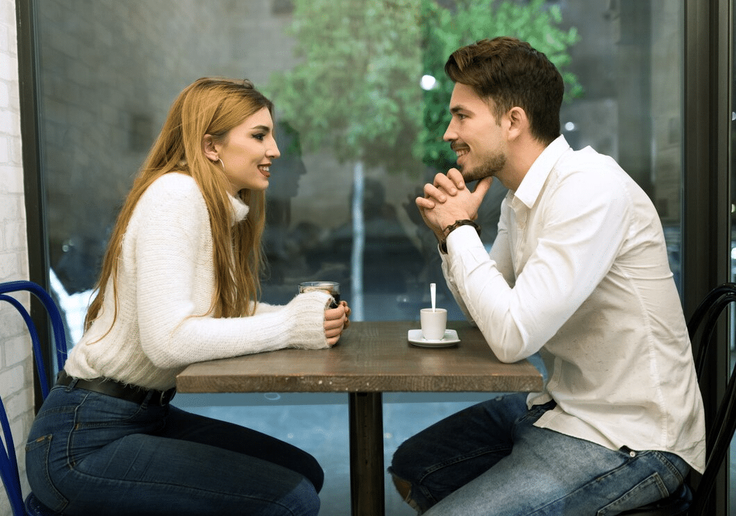 Young couple chatting and smiling outdoors