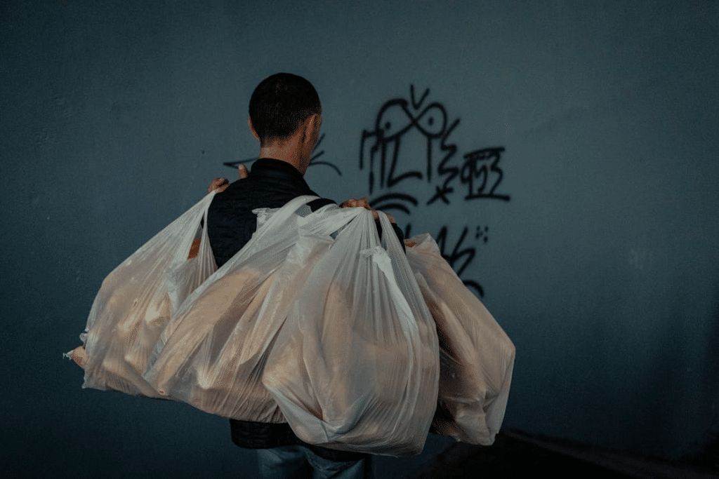 Man carrying groceries alone
