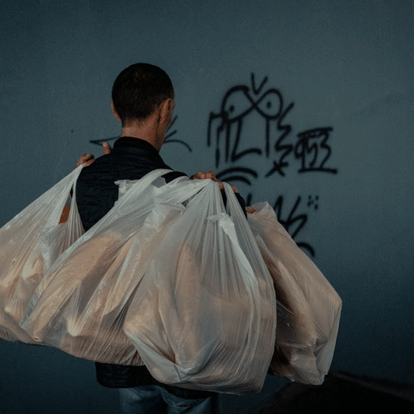 Man carrying groceries alone