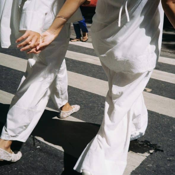 couple holding hands while walking quickly