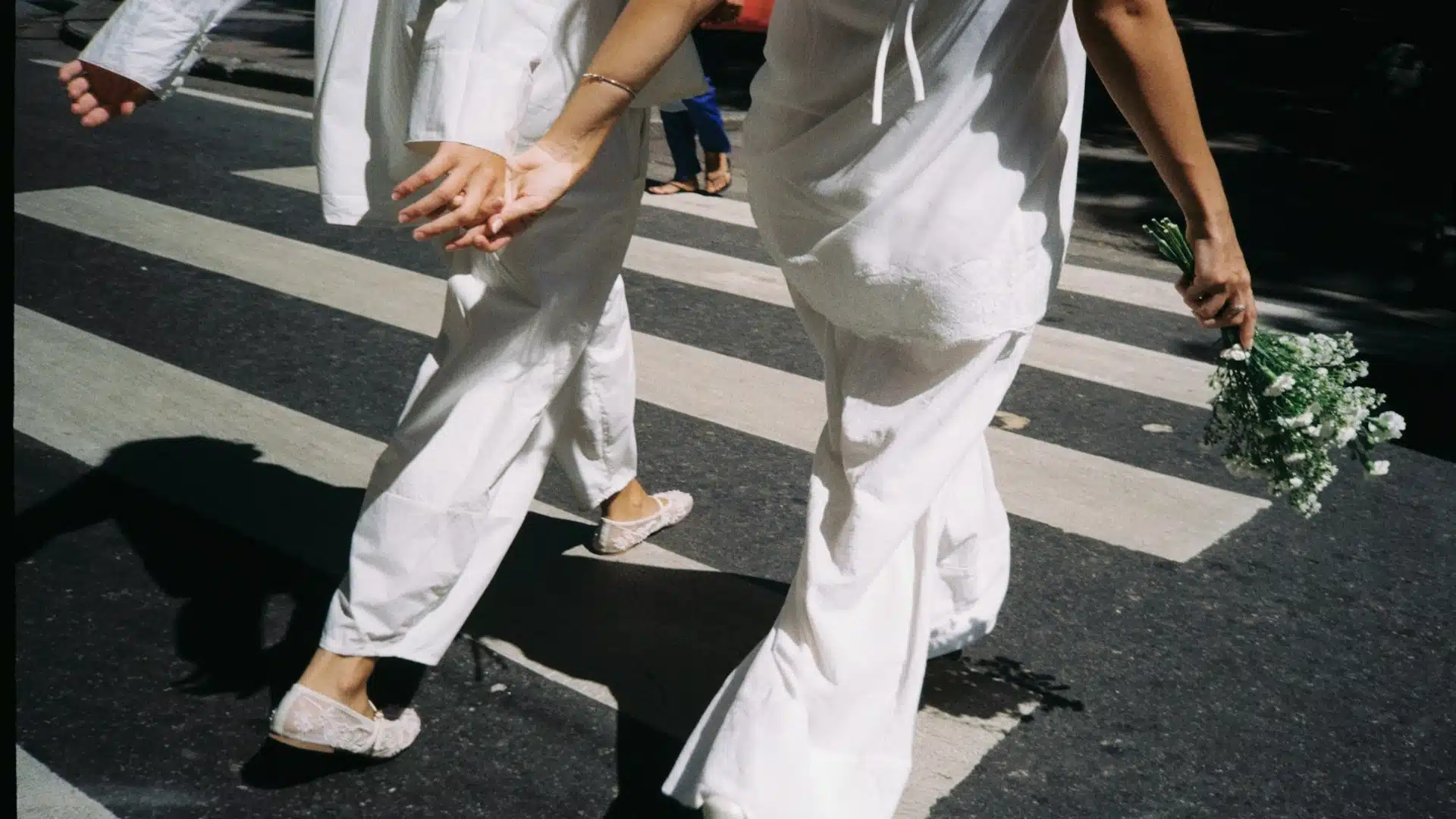 couple holding hands while walking quickly