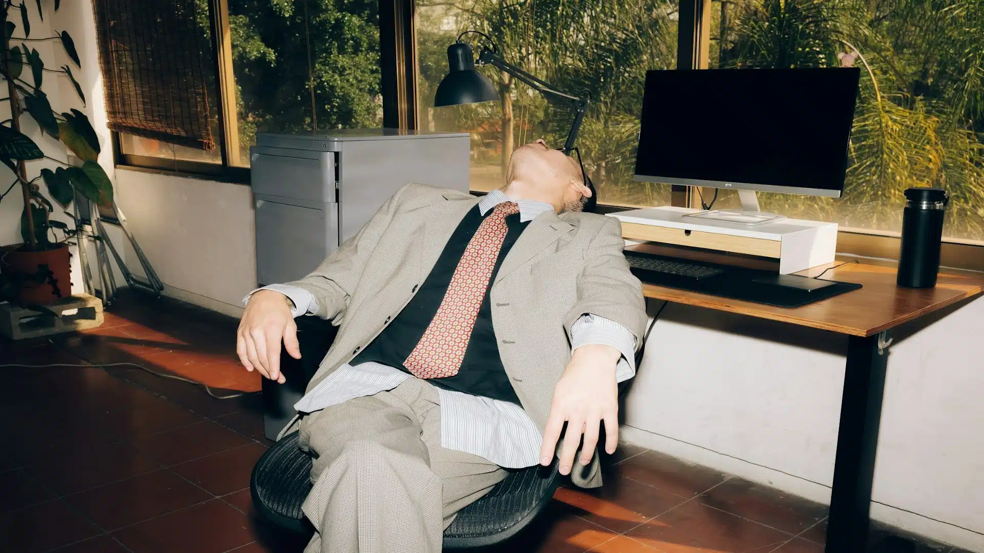 man sitting tired at desk