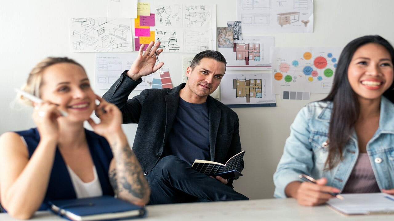 A man raising his hand at a meeting