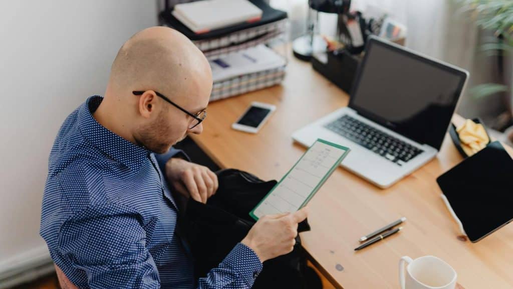 A man sitting at a desk reading a document