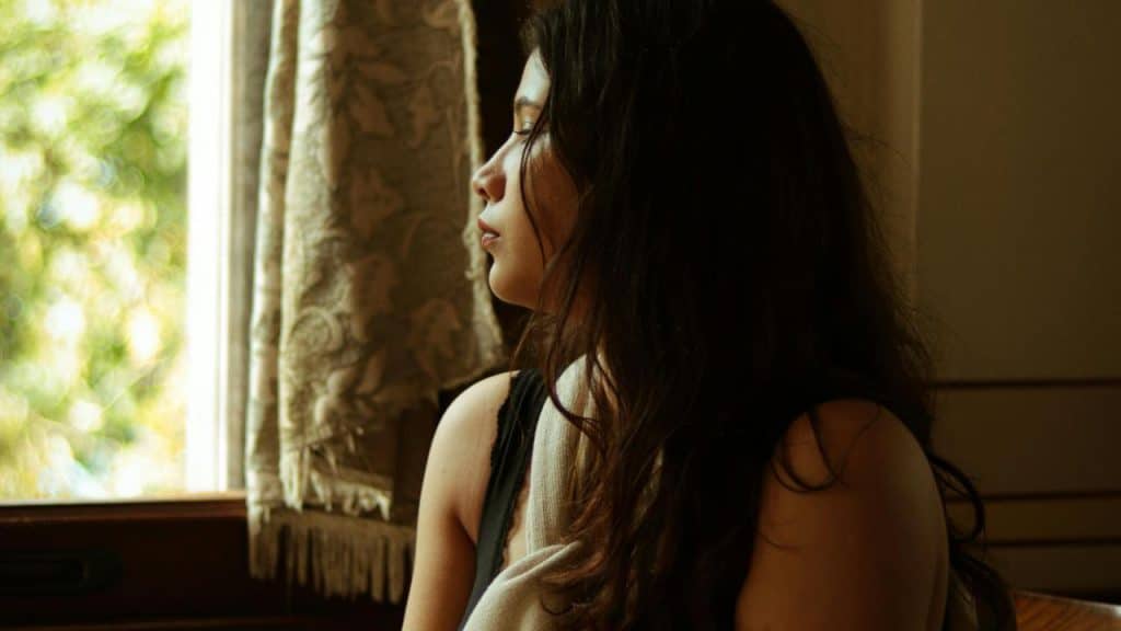 A woman looking out a window.