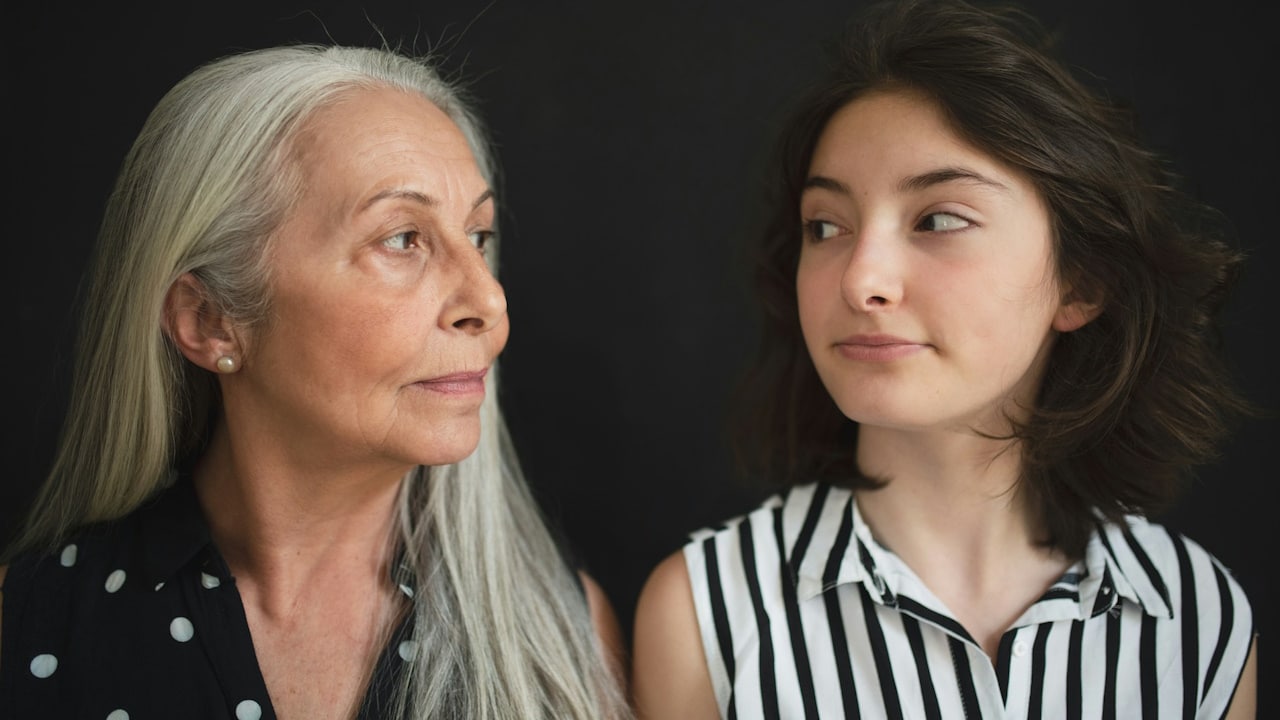 A mother and a daughter looking at each other.