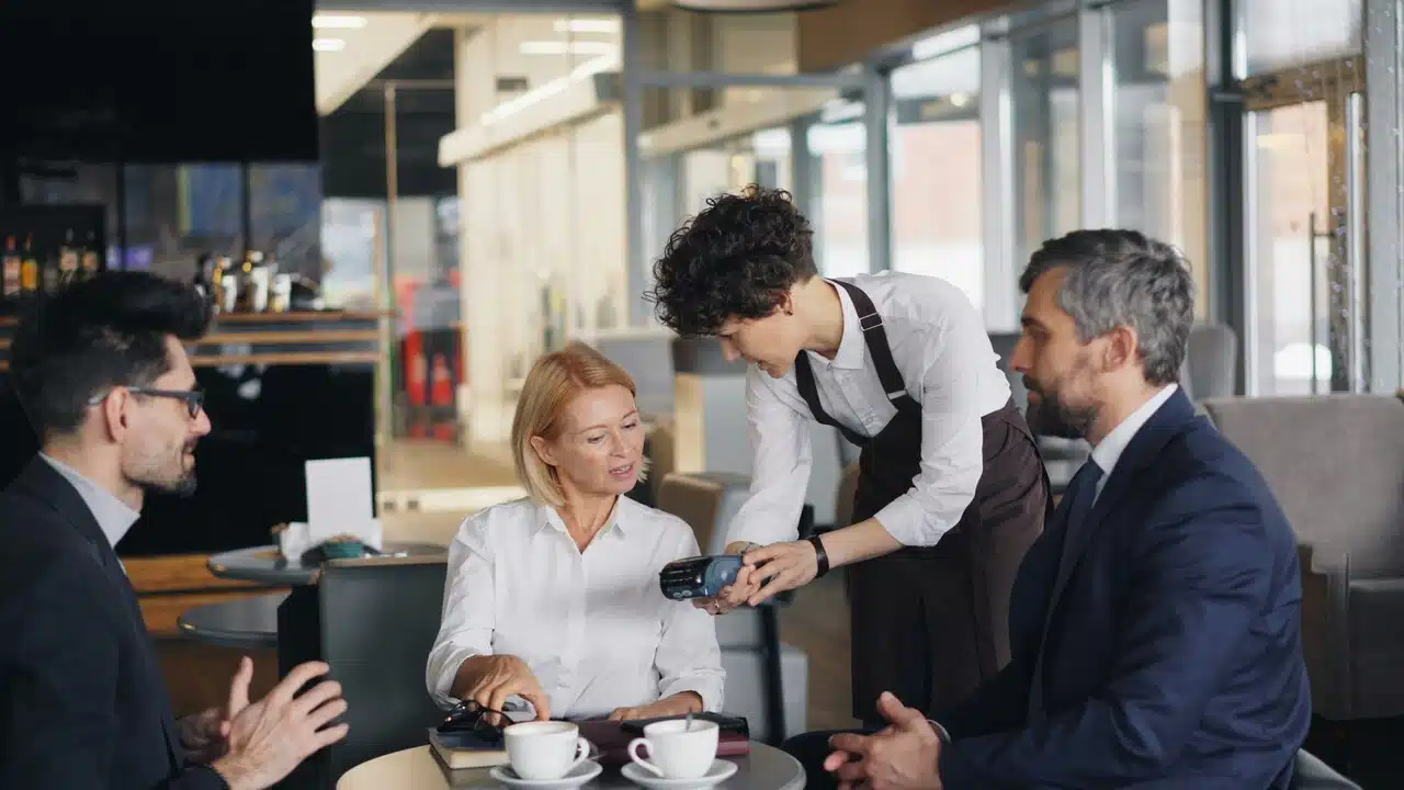 Colleagues talking to a waiter