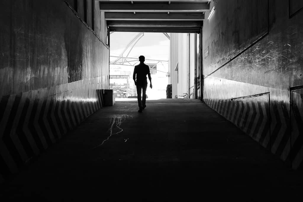 man walking alone city